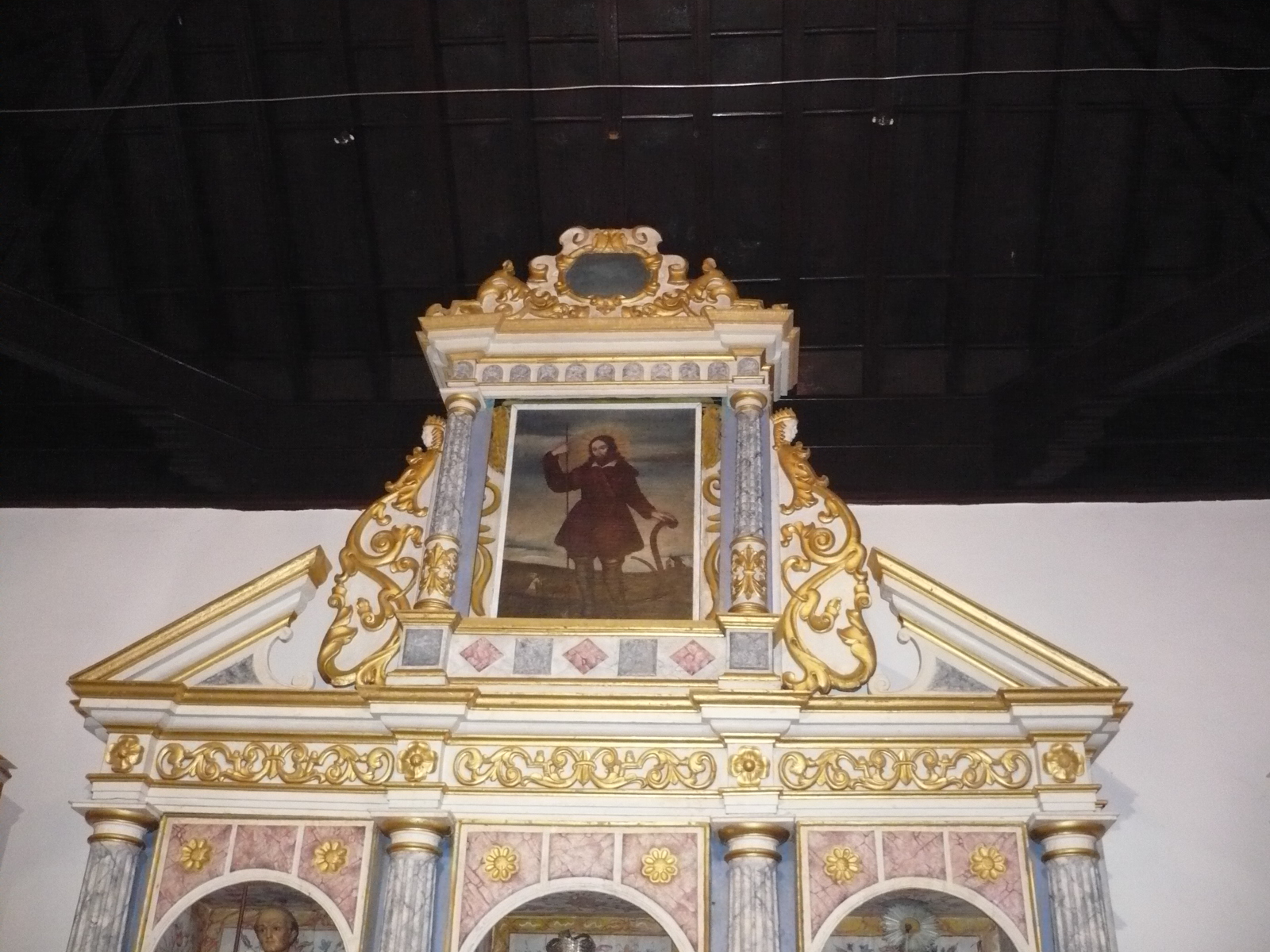 Cuadro de San Isidro Labrador en el remate del retablo